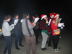 Group of people singing Christmas carols outdoors